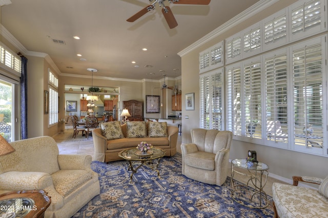 living room featuring crown molding, light tile patterned floors, and ceiling fan with notable chandelier