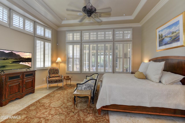 tiled bedroom with ceiling fan, a raised ceiling, and ornamental molding