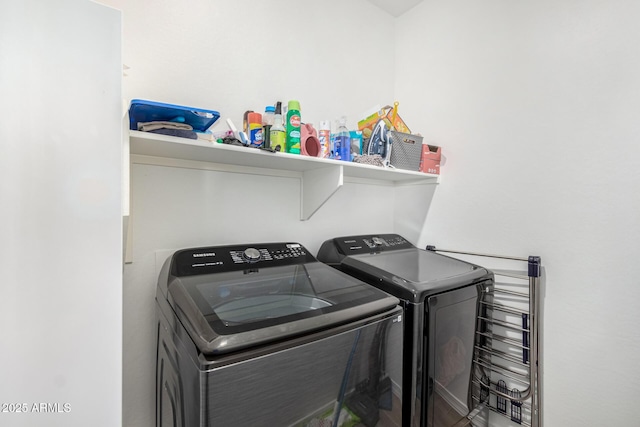 washroom with washing machine and clothes dryer