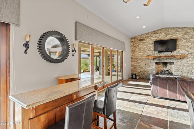 interior space featuring french doors, a fireplace, and vaulted ceiling