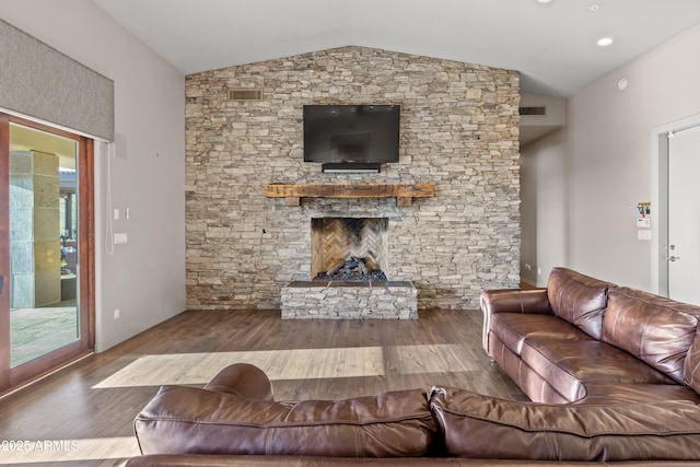 living room with a fireplace, wood-type flooring, and vaulted ceiling