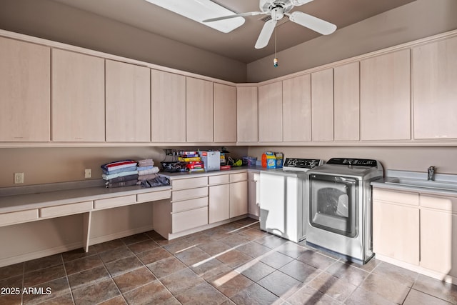 laundry room with ceiling fan, cabinets, sink, and washing machine and clothes dryer