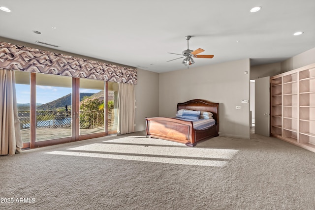 unfurnished bedroom with a mountain view, light carpet, access to outside, and ceiling fan