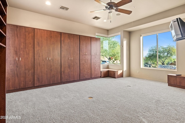 unfurnished bedroom with light carpet, a closet, and ceiling fan