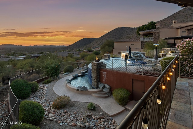 pool at dusk with a mountain view