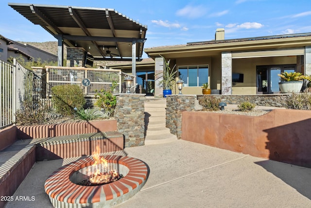 exterior space featuring a fire pit and a patio area