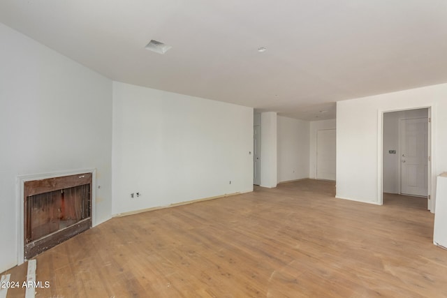 unfurnished living room featuring light hardwood / wood-style floors