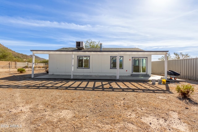 rear view of property featuring cooling unit and a patio area