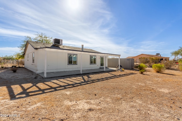 rear view of house featuring a patio and central AC