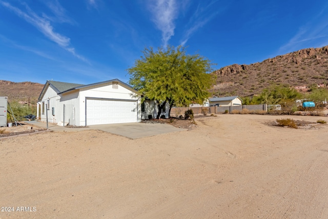 view of front of property with a mountain view and a garage