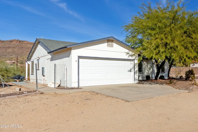 view of front facade with a mountain view and a garage