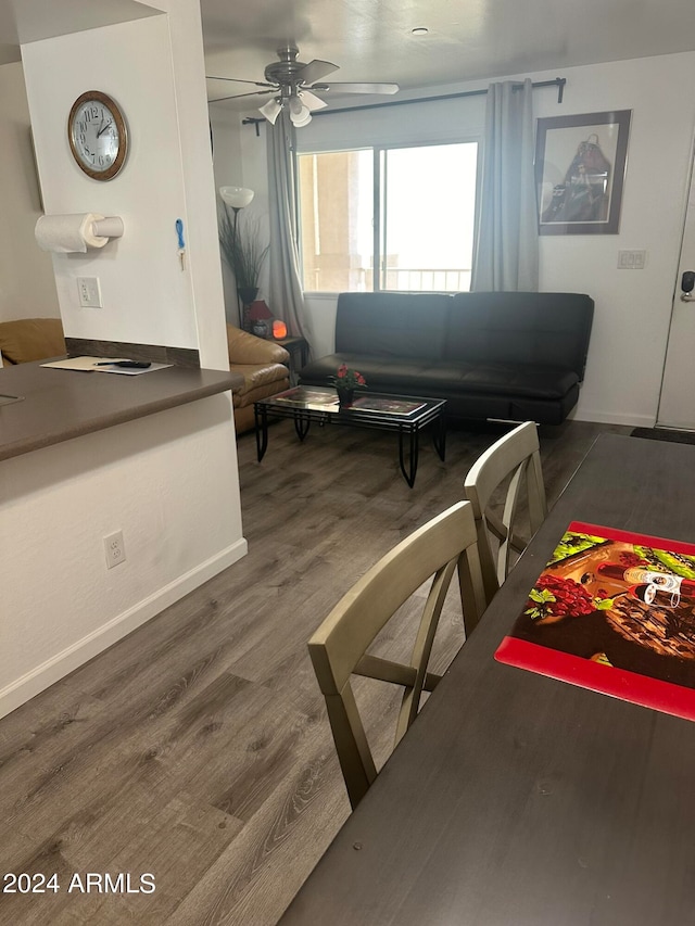 living room with dark wood-type flooring and ceiling fan