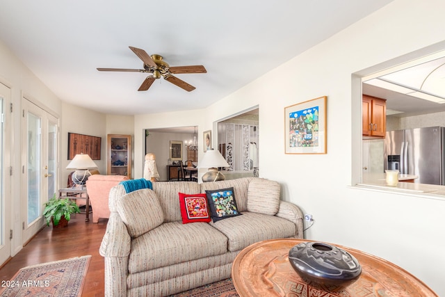 living room featuring dark wood-type flooring and ceiling fan