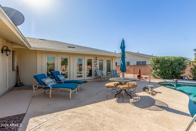 view of patio / terrace with french doors and a fenced in pool