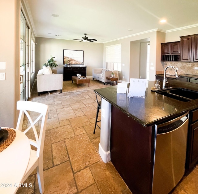 kitchen featuring a breakfast bar, dishwasher, sink, dark brown cabinetry, and crown molding