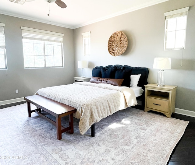 bedroom with ceiling fan, ornamental molding, and multiple windows