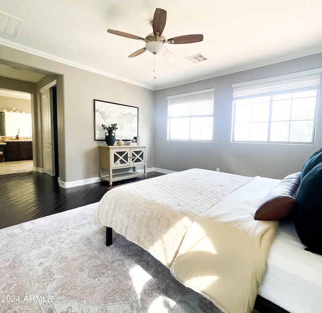 bedroom with crown molding, ceiling fan, and dark hardwood / wood-style floors