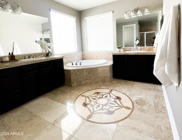 bathroom with vanity and separate shower and tub