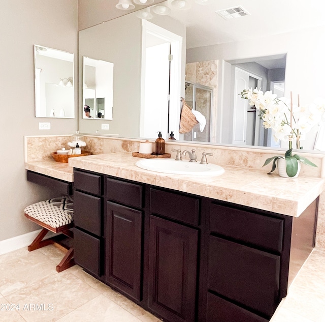 bathroom featuring walk in shower and vanity