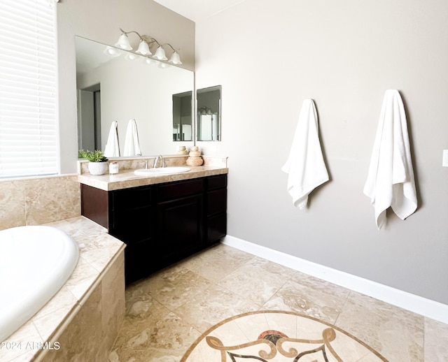 bathroom with vanity and a relaxing tiled tub