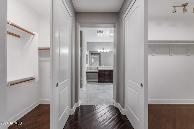 corridor with hardwood / wood-style floors