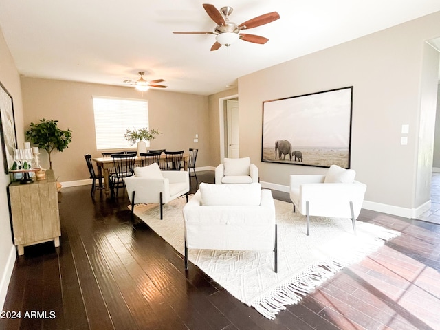 living room with ceiling fan and dark hardwood / wood-style flooring