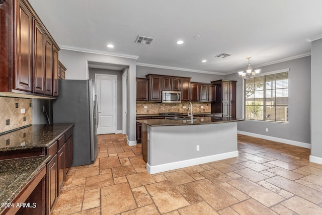 kitchen featuring sink, ornamental molding, appliances with stainless steel finishes, a notable chandelier, and pendant lighting