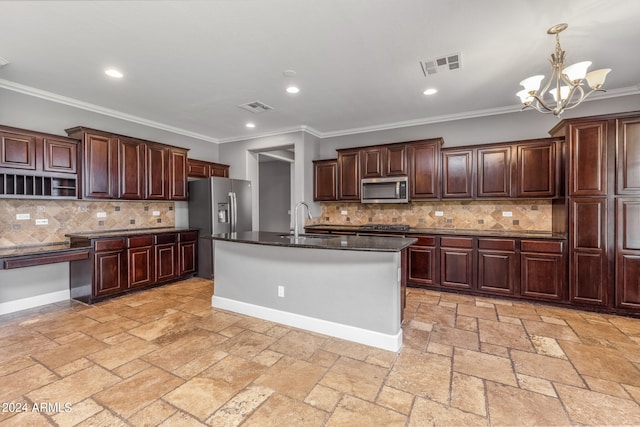 kitchen with pendant lighting, sink, stainless steel appliances, ornamental molding, and a center island with sink