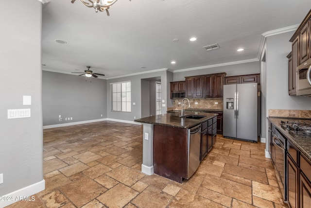 kitchen with tasteful backsplash, sink, a kitchen island with sink, stainless steel appliances, and crown molding