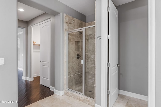 bathroom featuring a shower with shower door