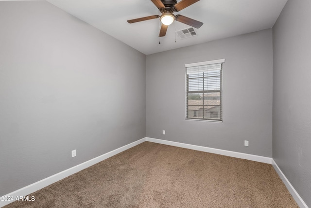 spare room featuring carpet flooring and ceiling fan