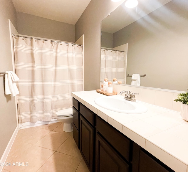 bathroom featuring a shower with curtain, vanity, toilet, and tile patterned flooring