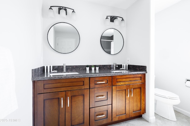 3907 E Marilyn Rd, Phoenix, AZ 85032 - bathroom featuring double vanity, toilet, and baseboards