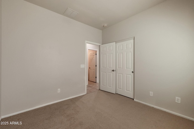 unfurnished bedroom with light colored carpet