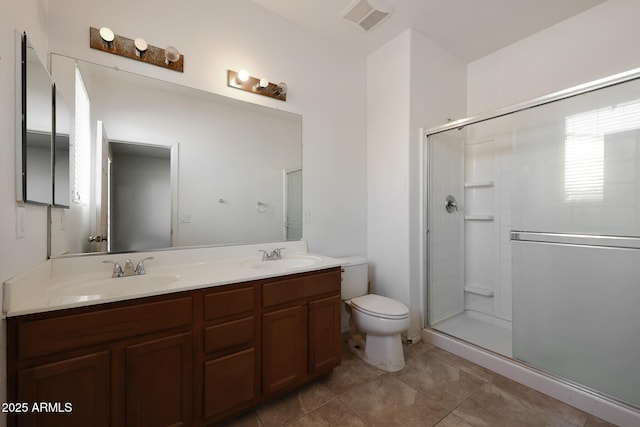 bathroom featuring toilet, tile patterned floors, walk in shower, and vanity