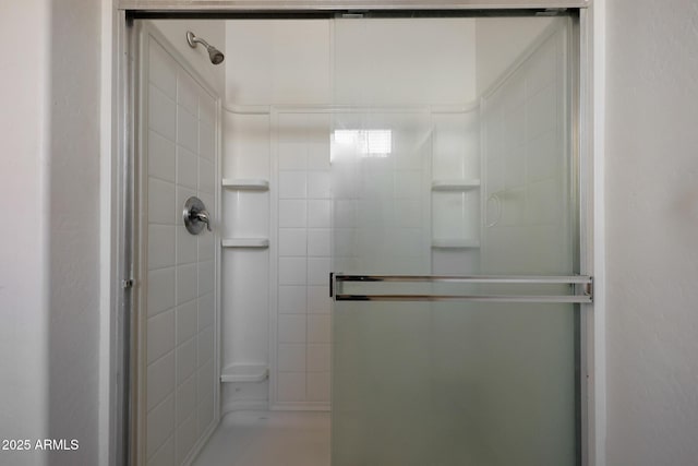 bathroom with a shower with door