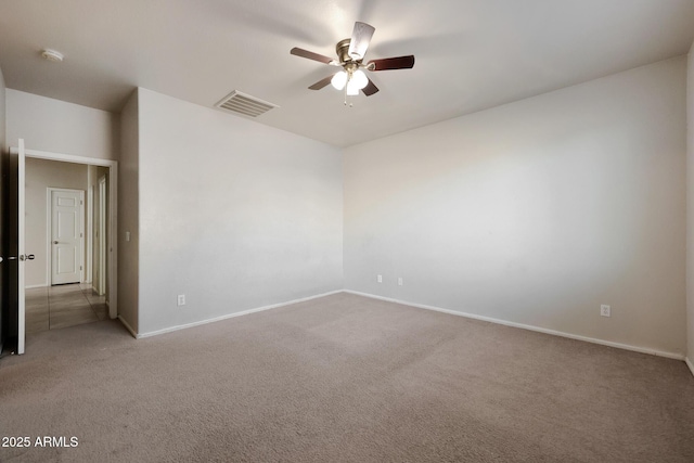 carpeted spare room featuring ceiling fan