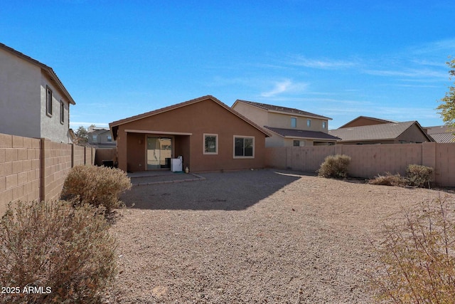 back of property with a patio