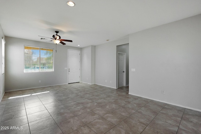 tiled empty room with ceiling fan