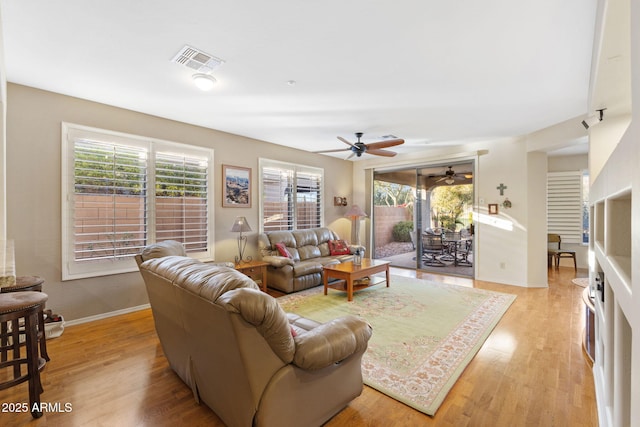 living room featuring light wood-type flooring and ceiling fan