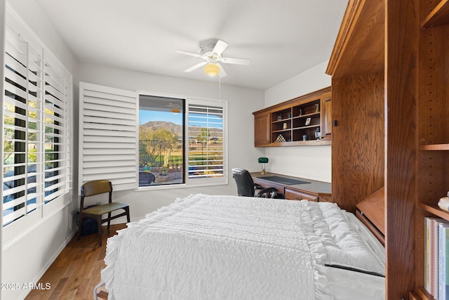 bedroom featuring multiple windows, ceiling fan, and hardwood / wood-style flooring