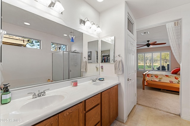 bathroom featuring ceiling fan, vanity, tile patterned floors, and a shower with shower door