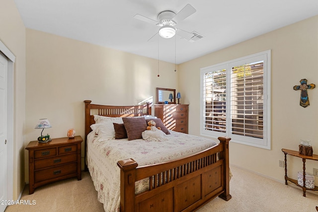 bedroom featuring a closet, light carpet, and ceiling fan