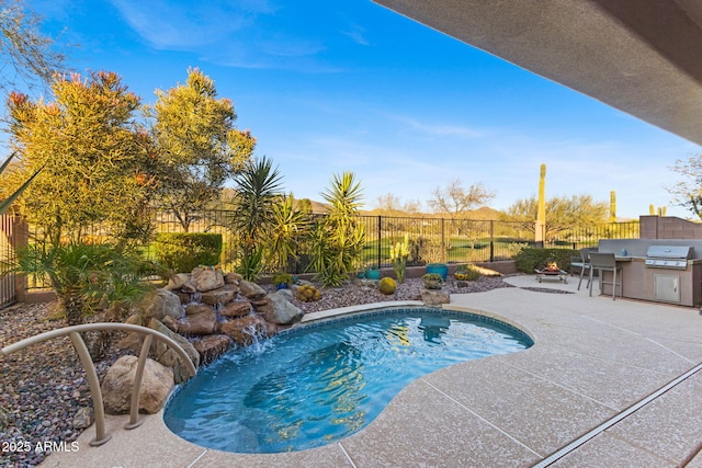 view of swimming pool featuring a grill and a patio