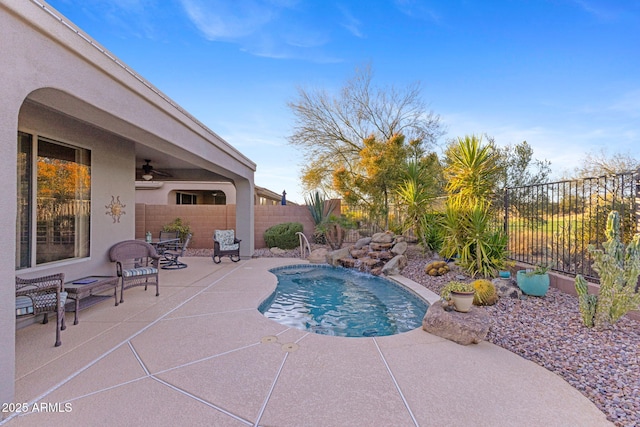 view of swimming pool featuring ceiling fan, a patio, and pool water feature