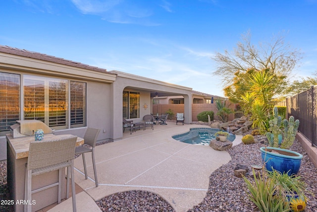 view of patio / terrace with area for grilling and a fenced in pool