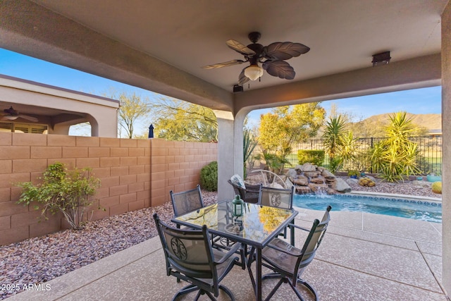 view of patio / terrace with ceiling fan, pool water feature, and a fenced in pool