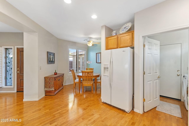 kitchen featuring ceiling fan, light wood-type flooring, and white fridge with ice dispenser