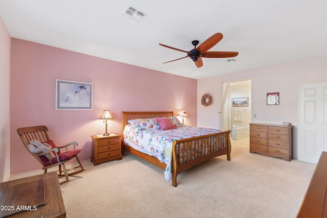 bedroom featuring ensuite bathroom, ceiling fan, and light carpet