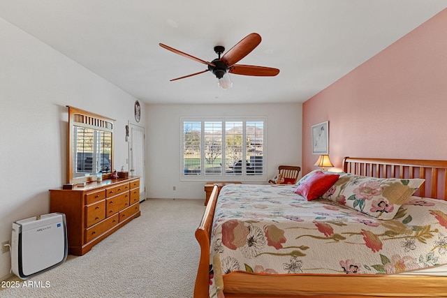 bedroom featuring light carpet and ceiling fan